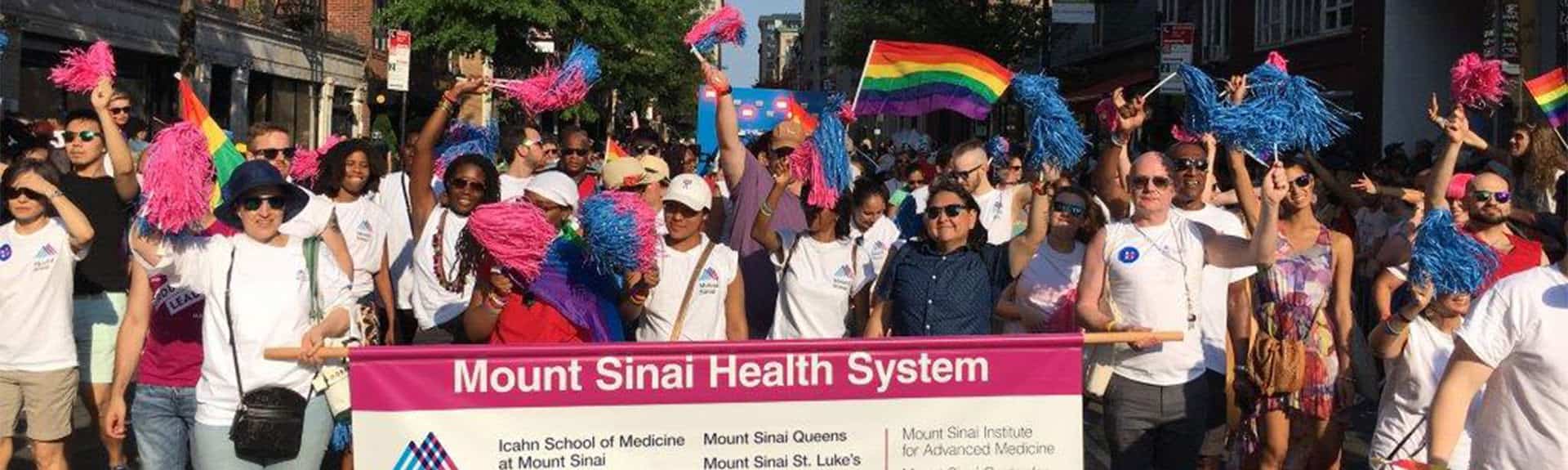 LGBT parade with walkers holding Mount Sinai banner