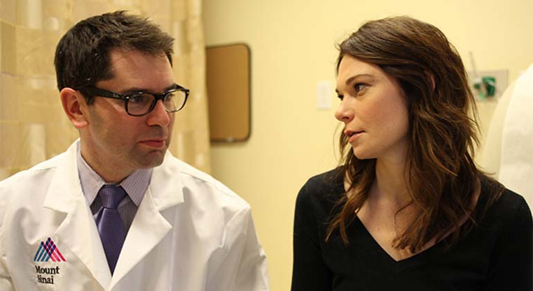 Image of doctor in glasses looking at patient