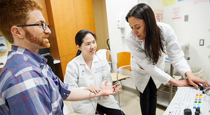 Image of Resident with Dr. Susan Shin and Dr. Jessica Robinson-Papp performing tests