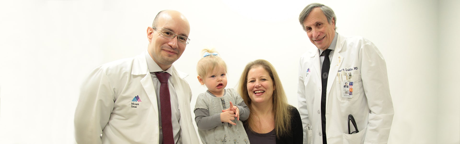 Image of Dr. Stephen Krieger and Dr. Fred Lublin with patient and child