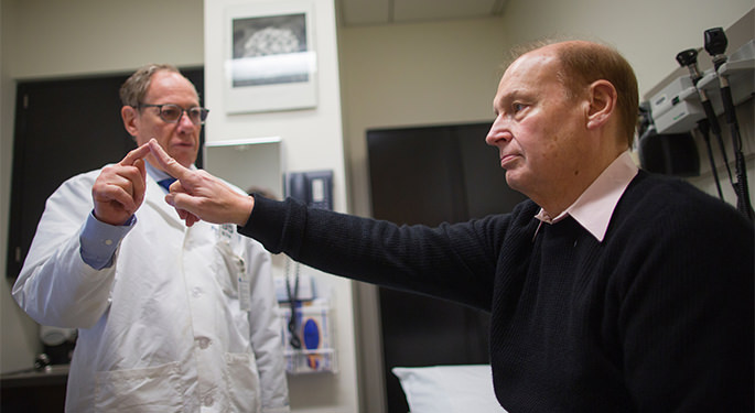 Dr. Aaron Miller performing tests with patient