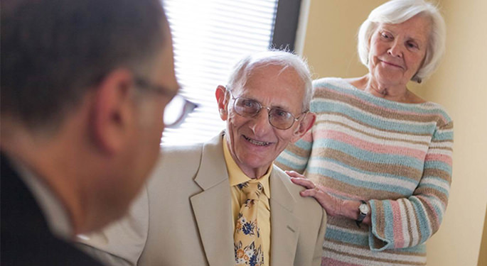 Image of doctor discussing with 2 elderly patients
