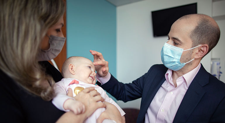 Image of doctor examining baby