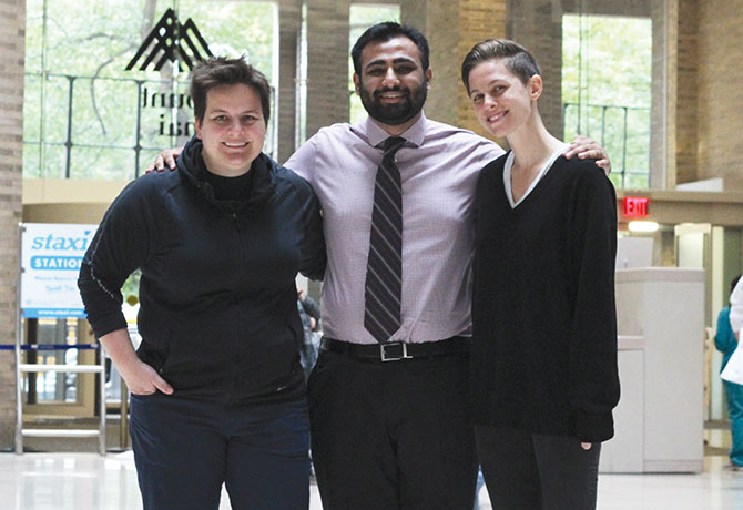 A photo of LGBTQ+PiM co-leaders Les James, Murad Khan, and Elizabeth Tarras