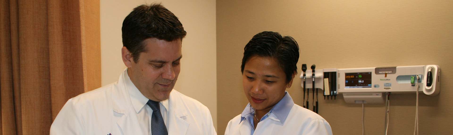 a male and a female physicians in an exam room