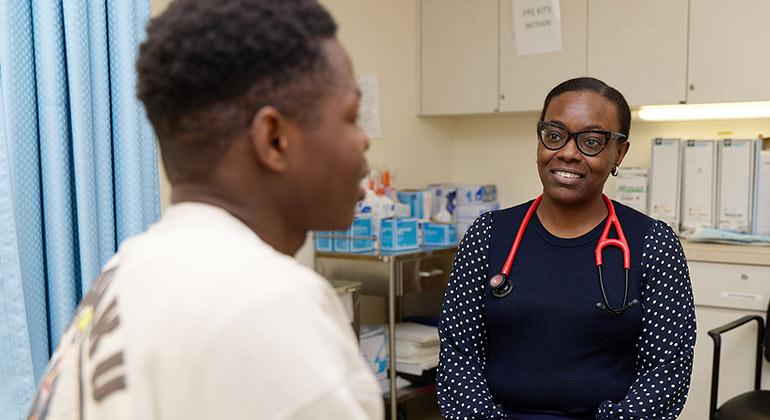 doctor talking to teenager