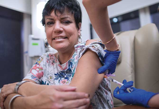 A photo shows patient Evelyn Ramos Santiago receiving an injection of mepolizumab at the Mount Sinai Therapeutic Infusion Center.