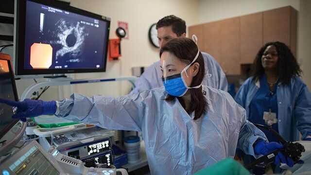Dr. Michelle K. Kim performs an endoscopy on a patient