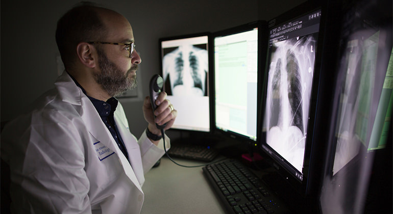 Radiologist looking at images on screen