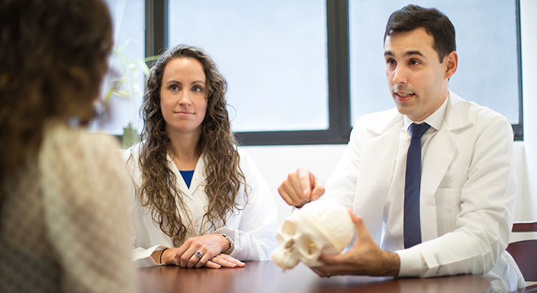 Doctors with model of skull