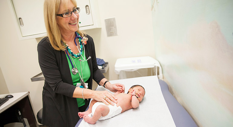 Photo of general pediatrics doctor examining baby