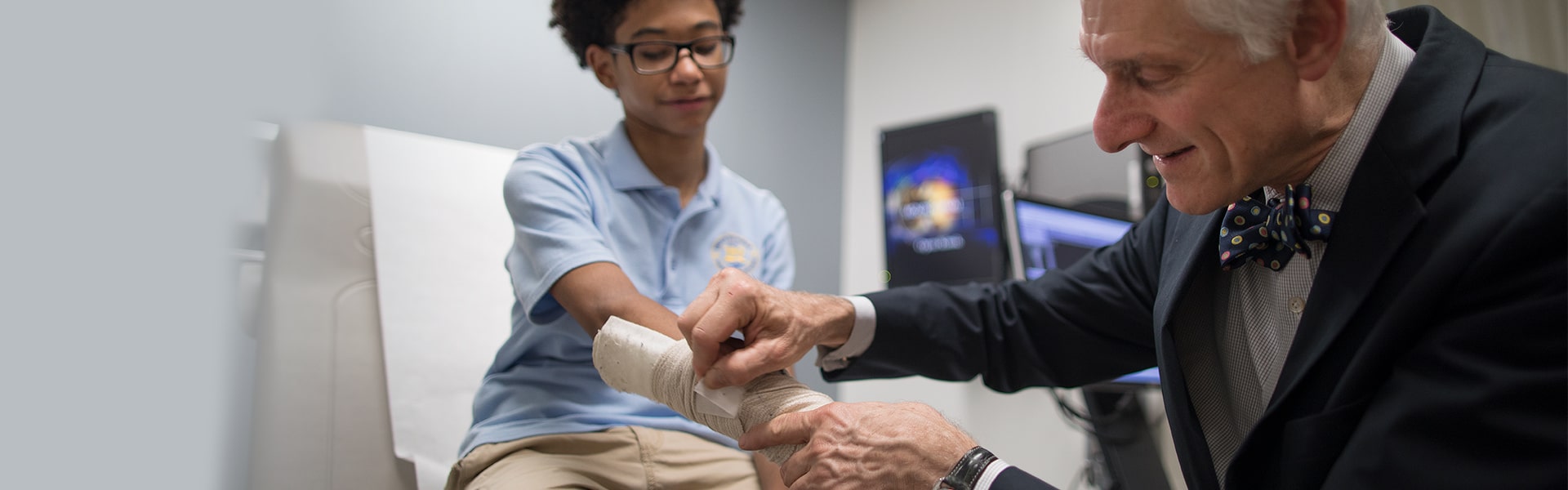 Orthopedic surgeon, Dr. Michael Hausman, with teen hand injury patient