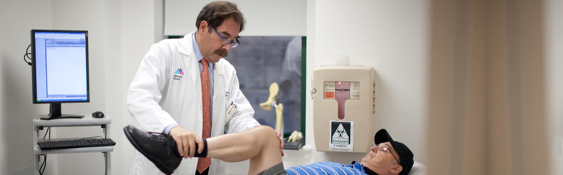 Orthopedic surgeon, Dr. Michael Bronson, with male joint replacement patient