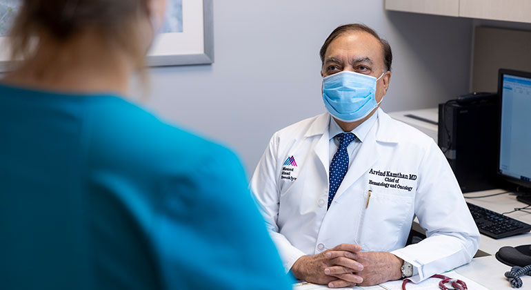 Masked doctor and patient