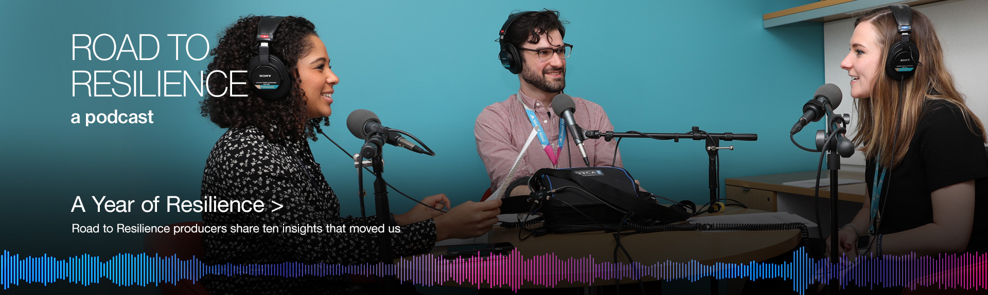 Image of three people speaking into microphones 