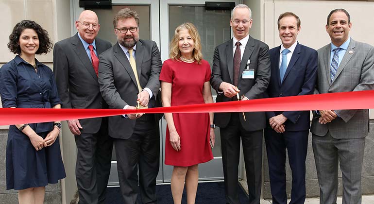 Men cut red ribbon