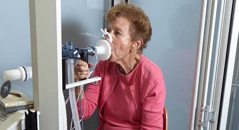 Woman using machine to help her breathe
