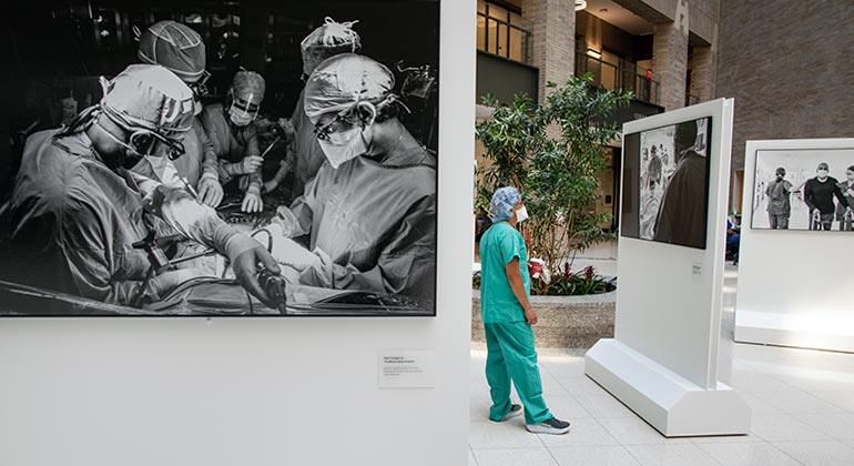 surgeon looking at a photo included in art installation