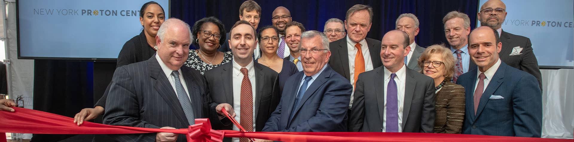 NY Proton Center team cutting ribbon