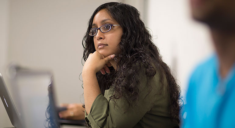 asian-american female at desk during class