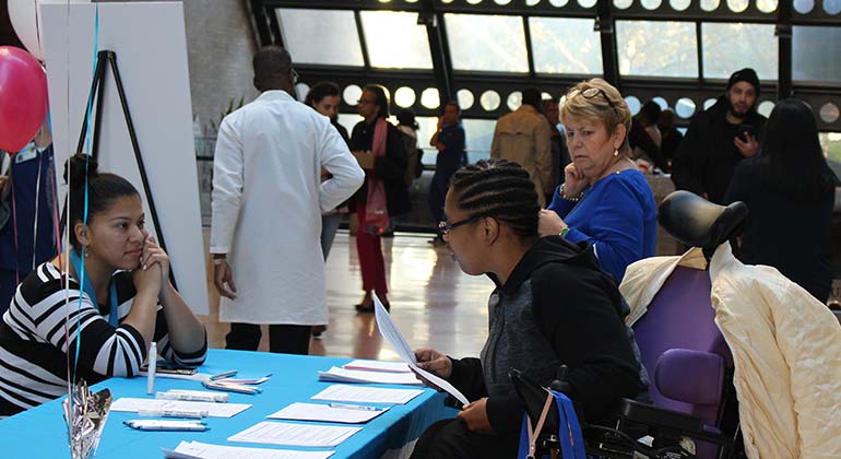 Staff speaking to attendee