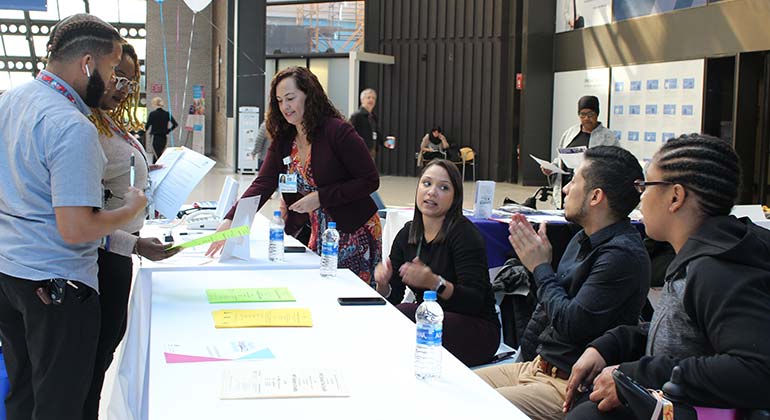 Staff speaking to attendees