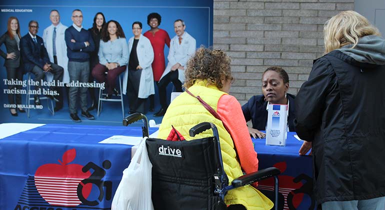 Staff speaking to attendees