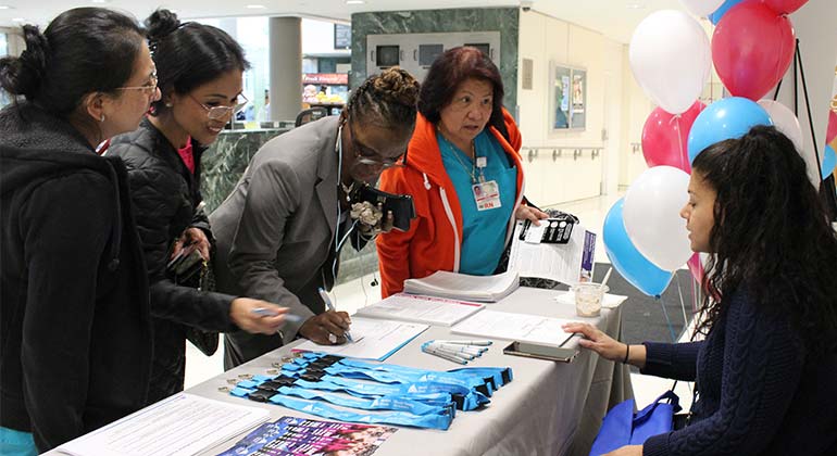 Attendees signing up for fair