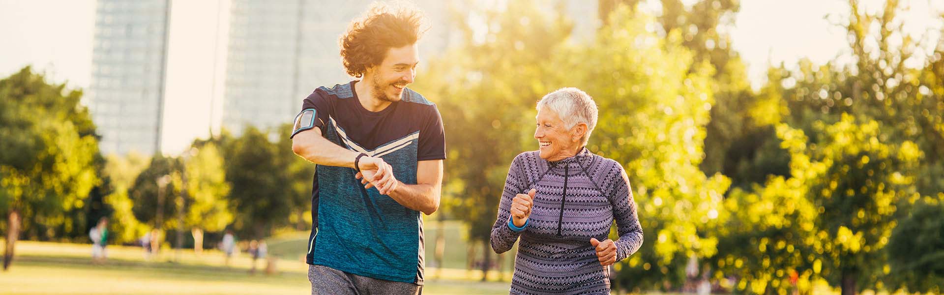An older woman and younger man jogging at the park