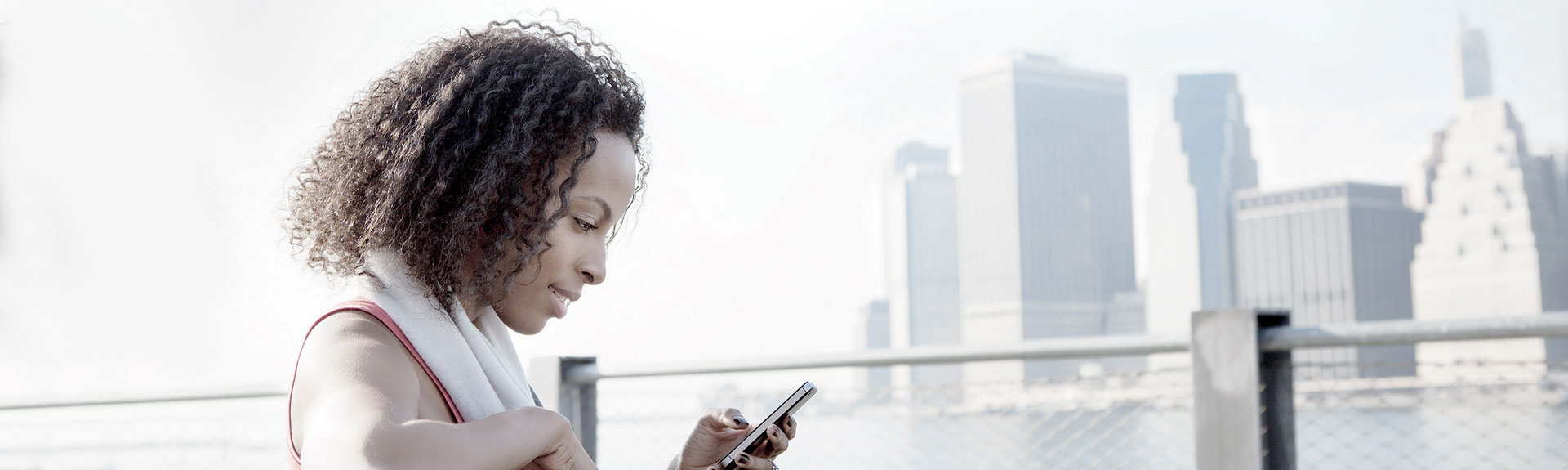 woman on a bench in front of cityscape