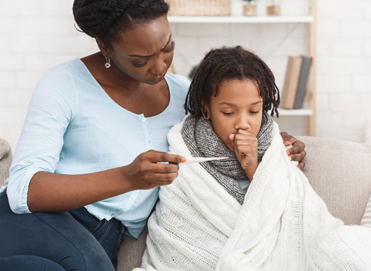 Photo of  Mom taking child’s temperature