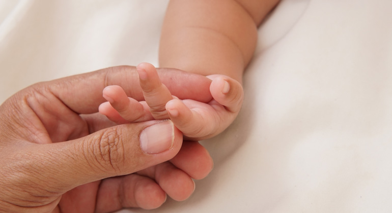 individual holding infant