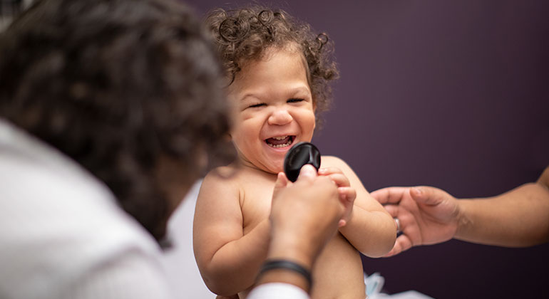 doctor making baby patient smile and laugh