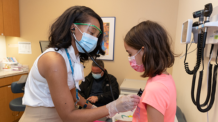 Image of doctor examining child