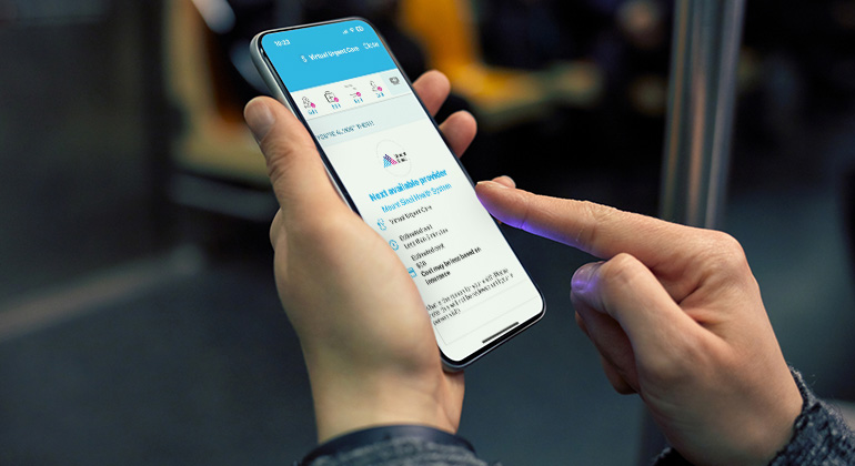 Hand holding phone with virtual urgent care on screen