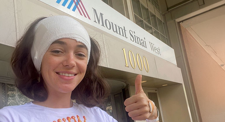 epilepsy patient giving a thumbs up after procedure