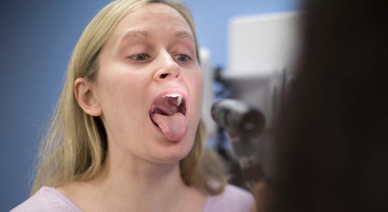 Patient opening mouth for doctor to check