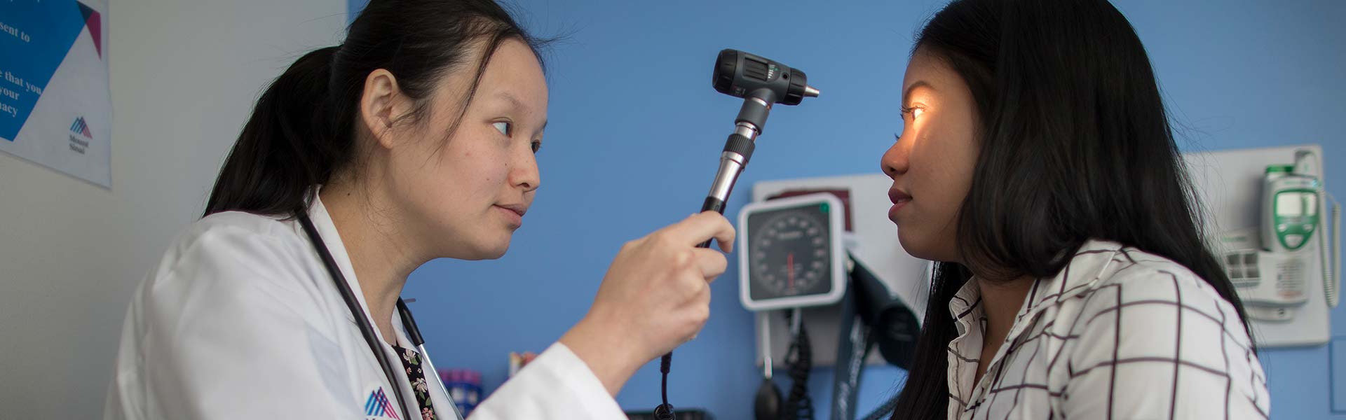 Doctor looking into patient