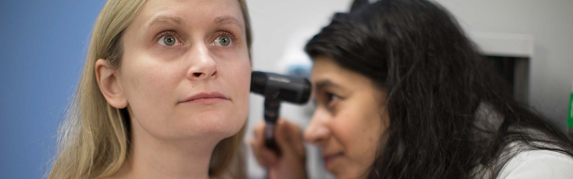 Doctor looking into patient