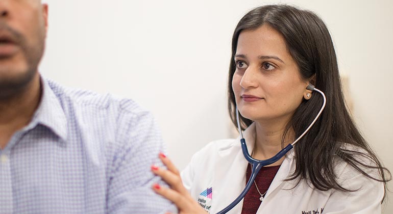 Doctor using her stethoscope.