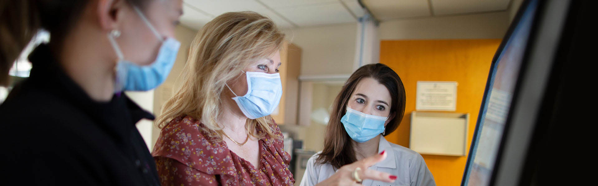 medical professionals review materials on computer