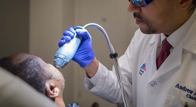 Image of Dr. Andrew Alexis with patient