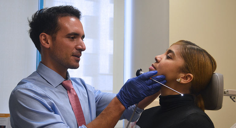 Doctor examining patients face/nose