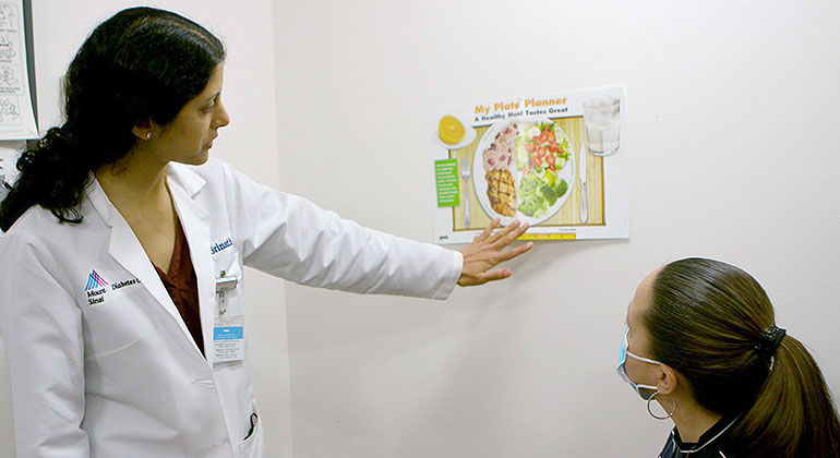 doctor pointing to illustration with patient