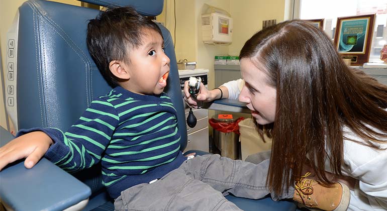 Doctor examining young boy