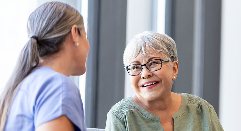 smiling geriatric patient with doctor