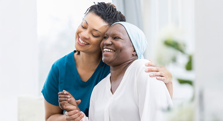 doctor giving geriatric patient a side hug