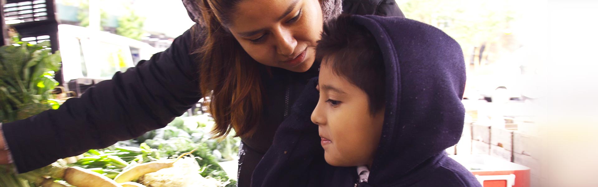 Mother and child pick out vegetables