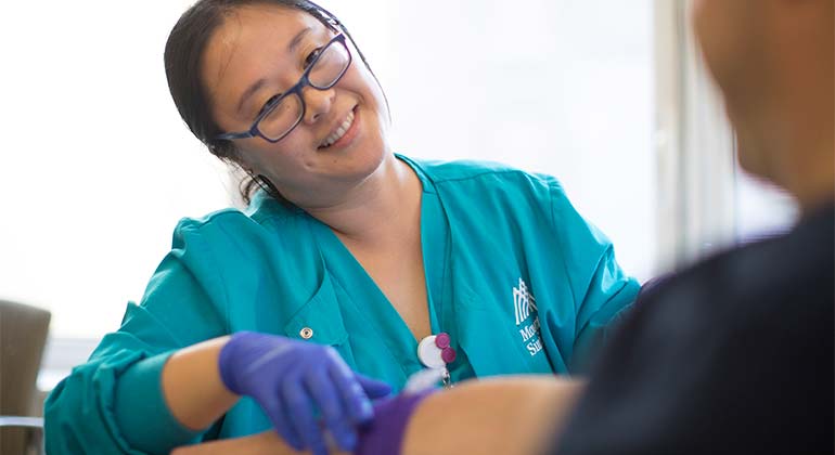 Nurse smiling at patient