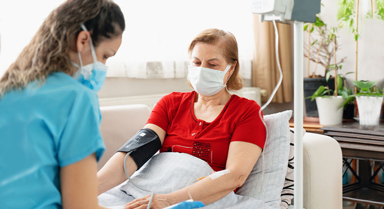 patient at home with nurse administering the infusion